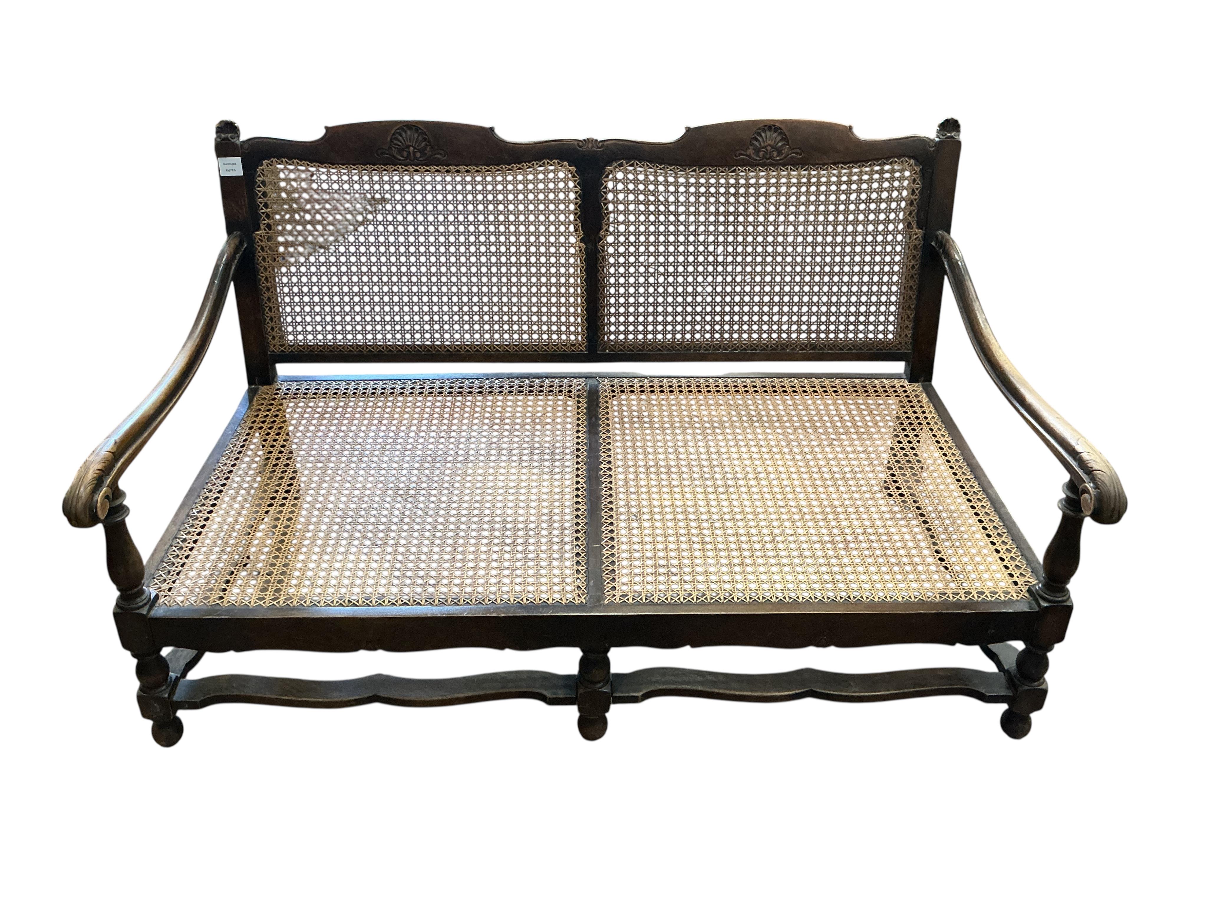 An early 20th century mahogany three piece bergere suite, settee width 174cm, height 74cm